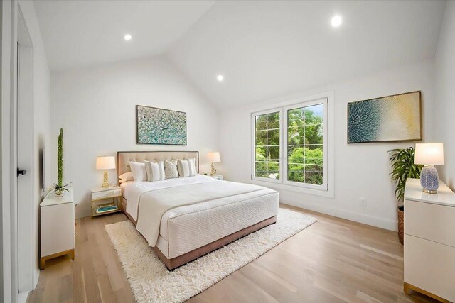 14 Kennedy Ln, West Islip, NY 11795 - bedroom with light wood-type flooring, vaulted ceiling, baseboards, and recessed lighting