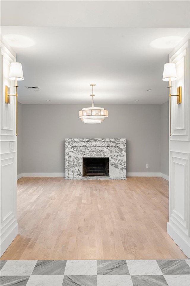 14 Kennedy Ln, West Islip, NY 11795 - unfurnished living room featuring baseboards, light wood-style floors, and a premium fireplace