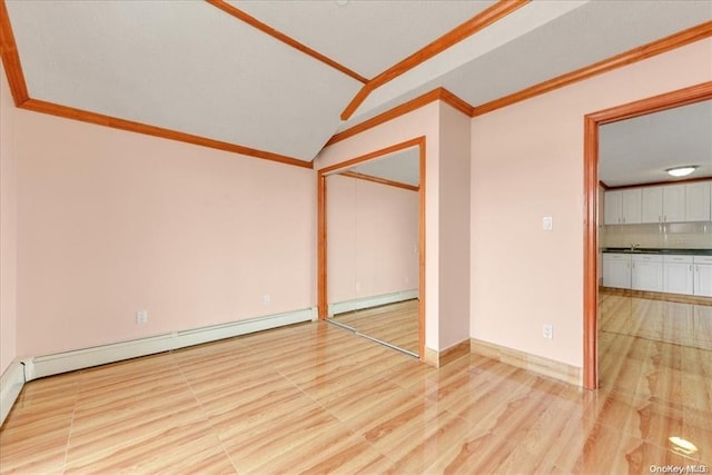 147-40 Jewel Ave, Kew Garden Hills, NY 11367 - unfurnished bedroom with a baseboard heating unit, ornamental molding, vaulted ceiling, and a closet