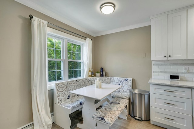 460 Old Town Rd Unit 25N, Port Jefferson Station, NY 11776 - dining space featuring crown molding, breakfast area, a baseboard heating unit, and light wood finished floors