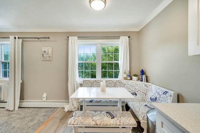 460 Old Town Rd Unit 25N, Port Jefferson Station, NY 11776 - dining room with healthy amount of natural light, wood finished floors, crown molding, and baseboard heating