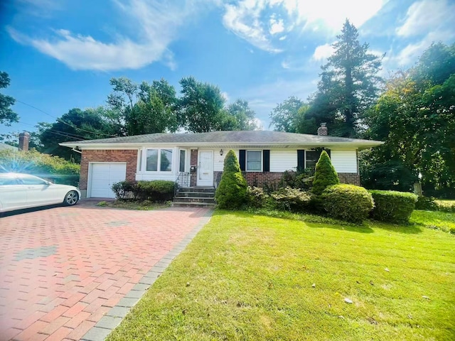 663 Woodbury Rd, Oyster Bay, NY 11791 - ranch-style house featuring brick siding, an attached garage, decorative driveway, a front lawn, and a chimney