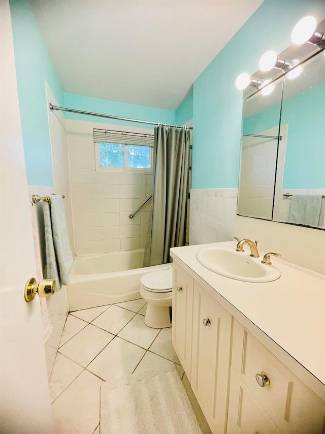 663 Woodbury Rd, Oyster Bay, NY 11791 - bathroom featuring shower / tub combo with curtain, vanity, toilet, tile patterned floors, and wainscoting