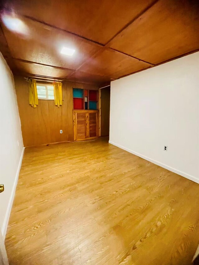 663 Woodbury Rd, Oyster Bay, NY 11791 - below grade area with wood finished floors and baseboards