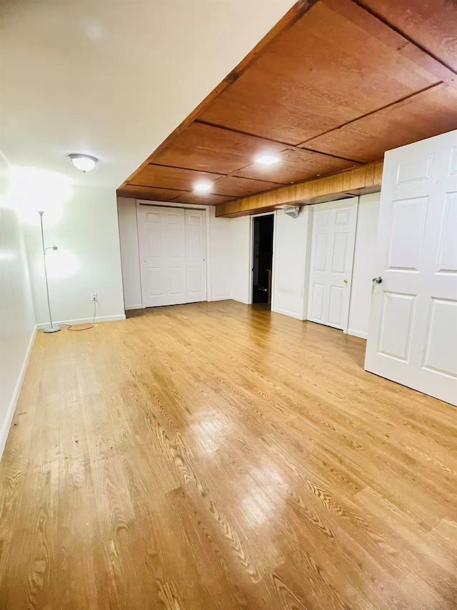 663 Woodbury Rd, Oyster Bay, NY 11791 - finished basement with light wood-style floors and baseboards