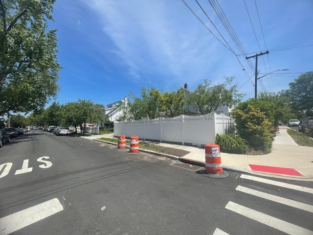 22-23 147th St, Whitestone, NY 11357 - view of asphalt road featuring sidewalks, curbs, and street lighting