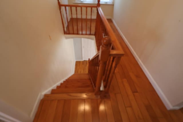 22-23 147th St, Whitestone, NY 11357 - stairway featuring wood finished floors and baseboards