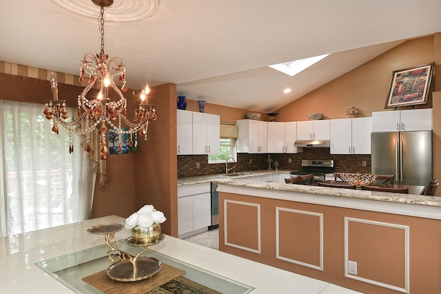 6 Country Ct, Farmingdale, NY 11735 - kitchen featuring stainless steel appliances, a sink, under cabinet range hood, a chandelier, and backsplash