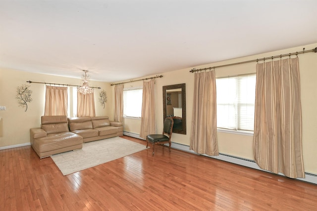 6 Country Ct, Farmingdale, NY 11735 - unfurnished living room featuring light wood-style floors, a chandelier, and baseboard heating