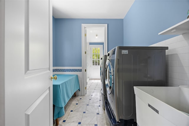47 Valley Rd, Old Westbury, NY 11568 - laundry room with washer / clothes dryer and light marble finish floors
