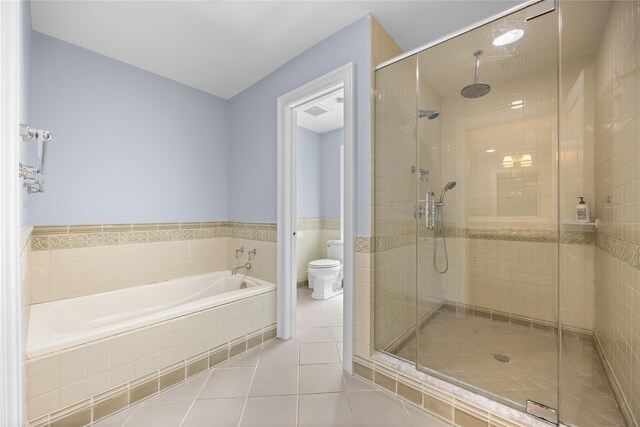 47 Valley Rd, Old Westbury, NY 11568 - full bath with toilet, tile patterned flooring, a shower stall, a garden tub, and tile walls