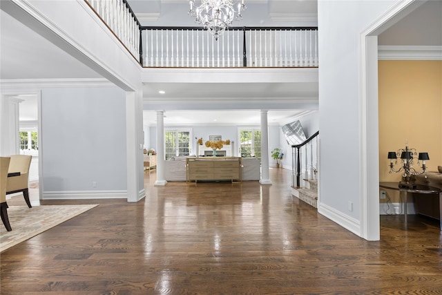 47 Valley Rd, Old Westbury, NY 11568 - entryway with decorative columns, stairs, wood finished floors, baseboards, and a towering ceiling