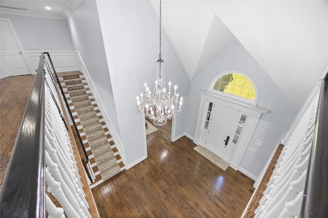 47 Valley Rd, Old Westbury, NY 11568 - foyer entrance with dark wood-type flooring, a chandelier, a towering ceiling, stairway, and ornamental molding