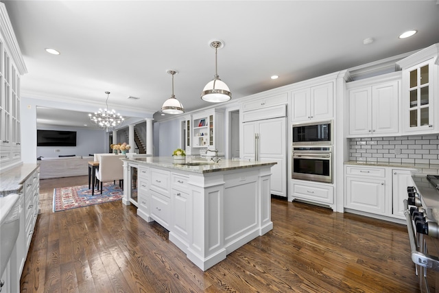 47 Valley Rd, Old Westbury, NY 11568 - kitchen with built in appliances, a chandelier, white cabinetry, recessed lighting, and ornamental molding