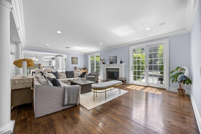 47 Valley Rd, Old Westbury, NY 11568 - living room featuring ornamental molding, wood finished floors, a glass covered fireplace, ornate columns, and baseboards