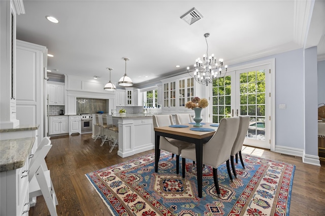 47 Valley Rd, Old Westbury, NY 11568 - dining area featuring a chandelier, dark wood-style flooring, recessed lighting, crown molding, and baseboards