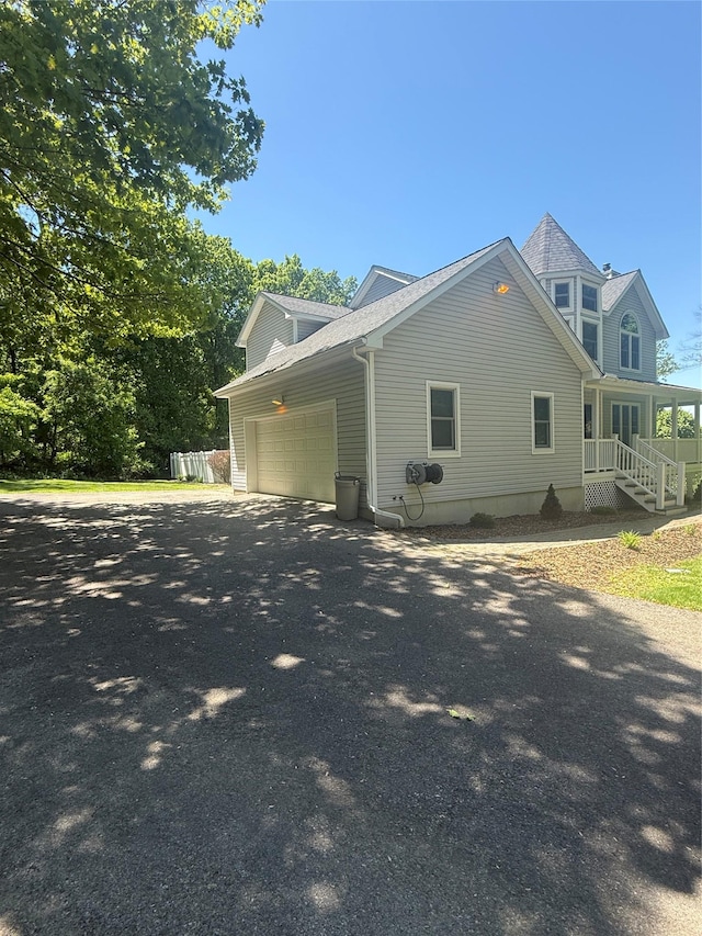 12 Rosell Ct, Lagrangeville, NY 12540 - view of side of home with a garage and asphalt driveway