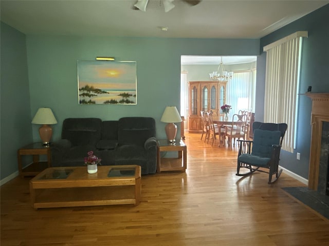 12 Rosell Ct, Lagrangeville, NY 12540 - living room featuring wood finished floors, a chandelier, a high end fireplace, and baseboards