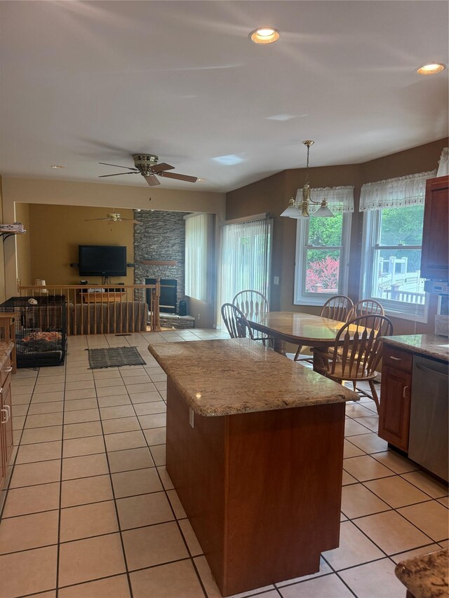 12 Rosell Ct, Lagrangeville, NY 12540 - kitchen featuring dishwasher, light tile patterned floors, ceiling fan, a stone fireplace, and a center island