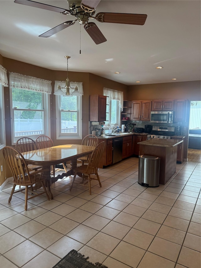 12 Rosell Ct, Lagrangeville, NY 12540 - kitchen with stainless steel appliances, light tile patterned floors, and a kitchen island