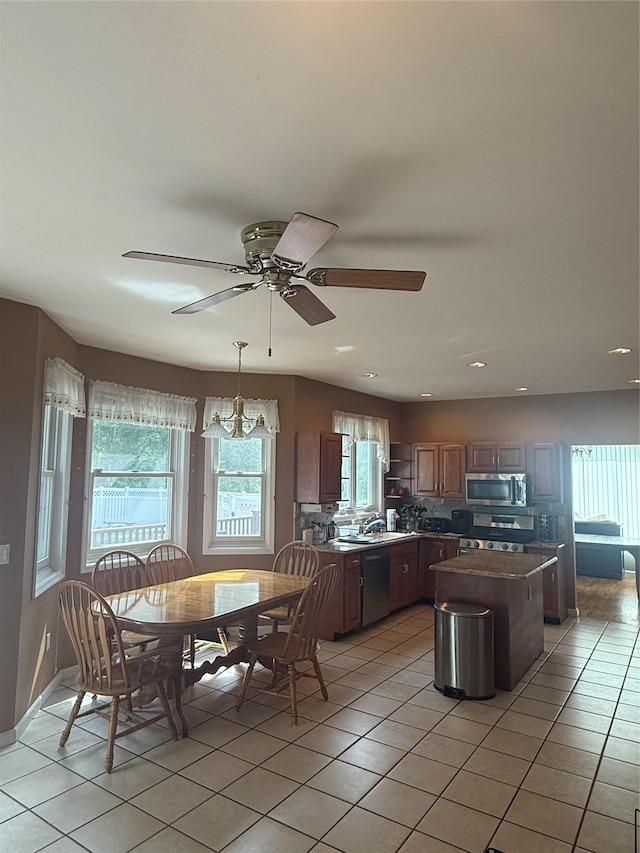 12 Rosell Ct, Lagrangeville, NY 12540 - kitchen with appliances with stainless steel finishes, a kitchen island, light tile patterned floors, a sink, and recessed lighting