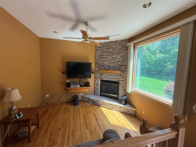 12 Rosell Ct, Lagrangeville, NY 12540 - living room with a ceiling fan, a stone fireplace, and wood finished floors