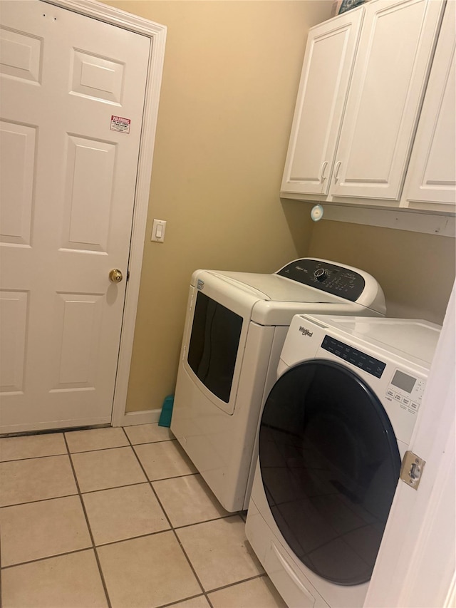 12 Rosell Ct, Lagrangeville, NY 12540 - laundry room featuring washing machine and clothes dryer, cabinet space, and light tile patterned floors