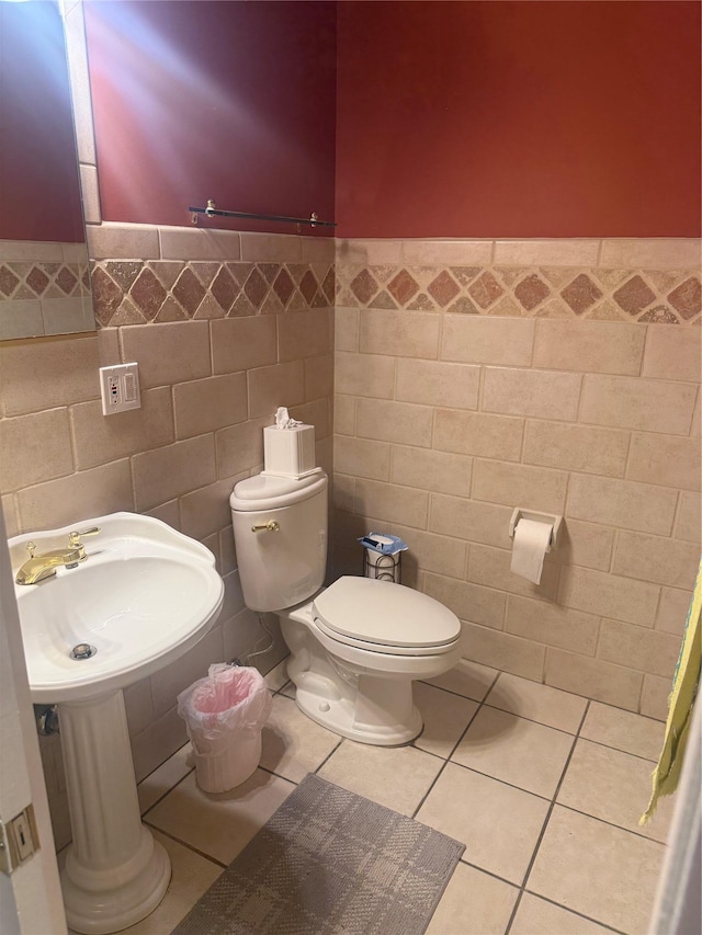 12 Rosell Ct, Lagrangeville, NY 12540 - bathroom featuring toilet, tile walls, a wainscoted wall, and tile patterned floors