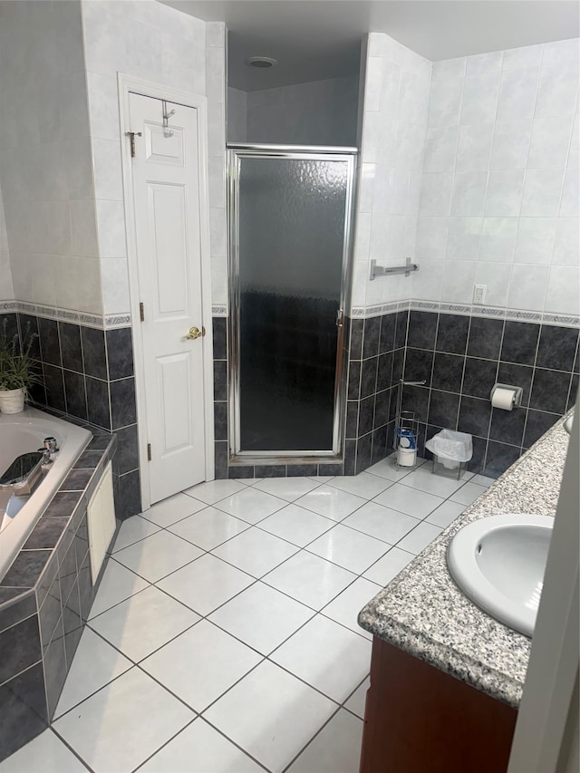 12 Rosell Ct, Lagrangeville, NY 12540 - bathroom with vanity, tile walls, a stall shower, tile patterned floors, and a bath