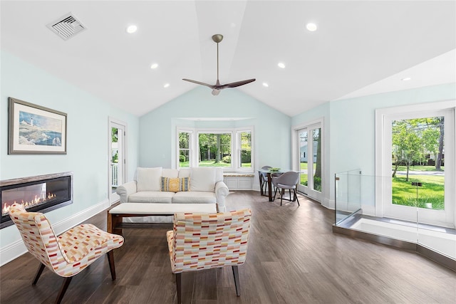 2360 Marlene Ln, Mattituck, NY 11952 - living room with wood finished floors, a glass covered fireplace, baseboards, ceiling fan, and lofted ceiling