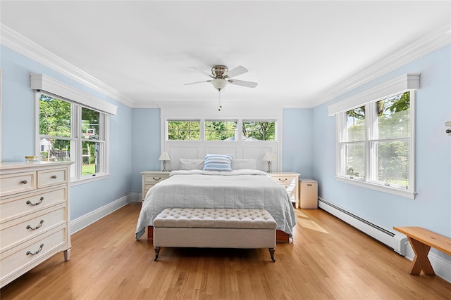 2360 Marlene Ln, Mattituck, NY 11952 - bedroom featuring baseboard heating, light wood-style floors, ornamental molding, baseboards, and a ceiling fan