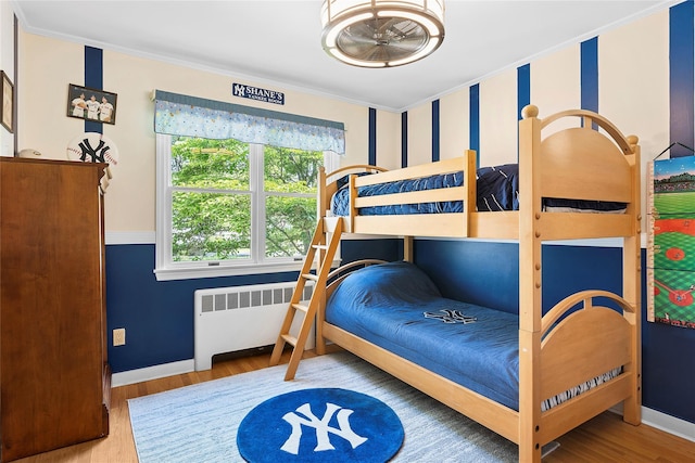 2360 Marlene Ln, Mattituck, NY 11952 - bedroom with radiator, crown molding, wood finished floors, and baseboards