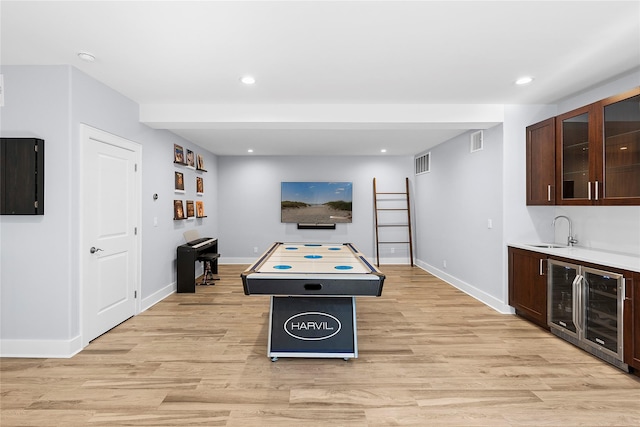 2360 Marlene Ln, Mattituck, NY 11952 - recreation room featuring wine cooler, bar with sink, light wood-style floors, baseboards, and recessed lighting