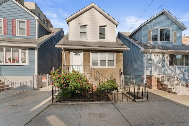 1856 Edison Ave, Bronx, NY 10461 - view of front facade featuring a gate, a shingled roof, and stone siding