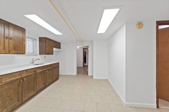 1856 Edison Ave, Bronx, NY 10461 - kitchen with a sink, light countertops, baseboards, and light tile patterned floors