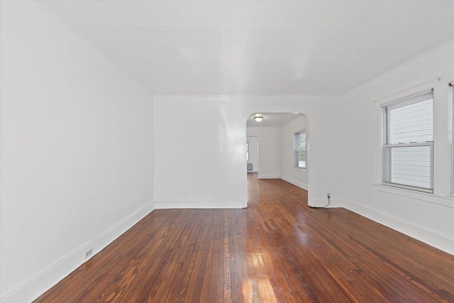 1856 Edison Ave, Bronx, NY 10461 - spare room featuring arched walkways, wood-type flooring, baseboards, and ornamental molding