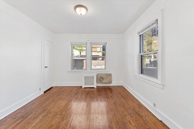 1856 Edison Ave, Bronx, NY 10461 - spare room featuring radiator heating unit, wood finished floors, plenty of natural light, and baseboards