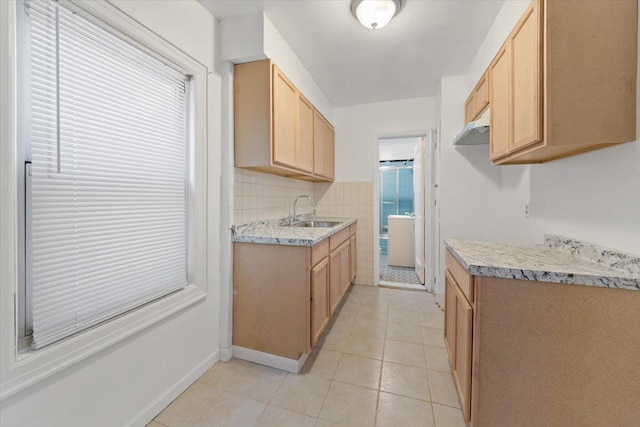 1856 Edison Ave, Bronx, NY 10461 - kitchen with a sink, light brown cabinets, light tile patterned floors, baseboards, and under cabinet range hood