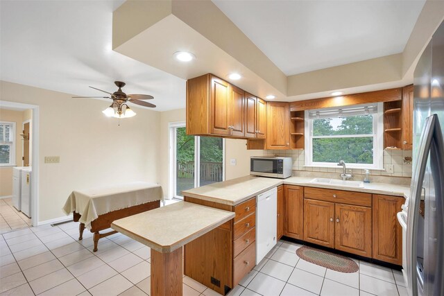 7 Mailler Ave, Cornwall, NY 12518 - kitchen with stainless steel appliances, a sink, open shelves, a peninsula, and backsplash
