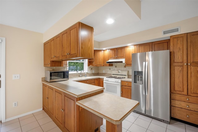 7 Mailler Ave, Cornwall, NY 12518 - kitchen featuring stainless steel appliances, under cabinet range hood, a peninsula, light countertops, and a sink