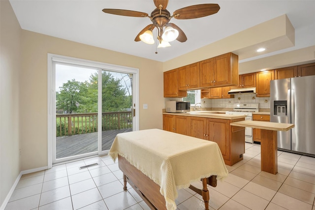 7 Mailler Ave, Cornwall, NY 12518 - kitchen featuring appliances with stainless steel finishes, under cabinet range hood, light countertops, decorative backsplash, and light tile patterned floors