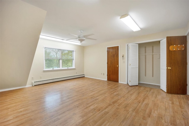 7 Mailler Ave, Cornwall, NY 12518 - unfurnished bedroom with a baseboard heating unit, multiple closets, light wood-style flooring, and baseboards