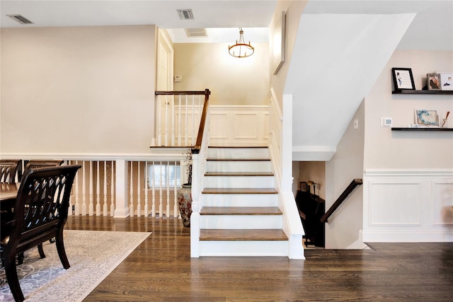 651 Hyman Ave, Bay Shore, NY 11706 - stairway with wood finished floors and a chandelier