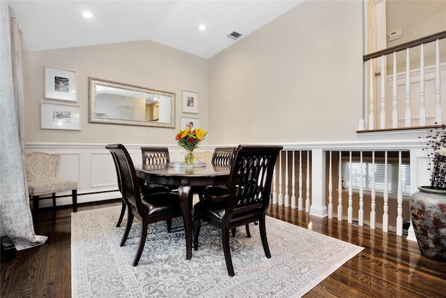 651 Hyman Ave, Bay Shore, NY 11706 - dining room with vaulted ceiling, wood finished floors, a baseboard heating unit, a wainscoted wall, and recessed lighting