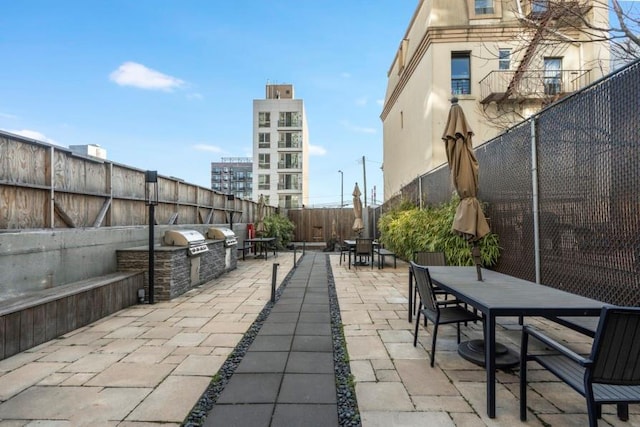 11-24 31st Ave Unit 5E, Astoria, NY 11106 - fenced backyard with outdoor dining space and a patio