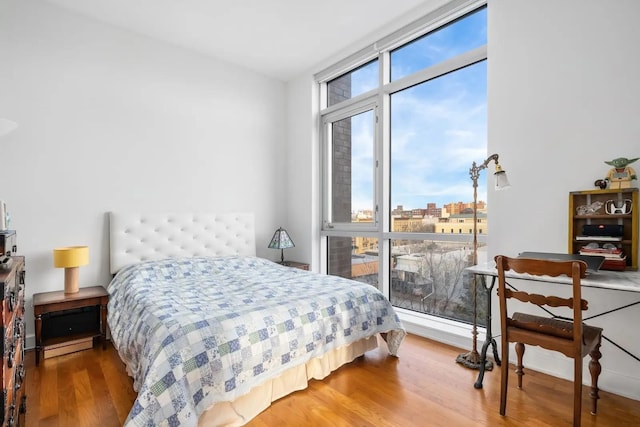 11-24 31st Ave Unit 5E, Astoria, NY 11106 - bedroom featuring wood finished floors and a view of city