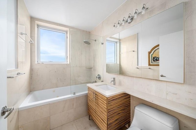11-24 31st Ave Unit 5E, Astoria, NY 11106 - full bath with tiled shower / bath combo, toilet, vanity, and tile walls