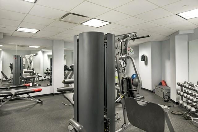 11-24 31st Ave Unit 5E, Astoria, NY 11106 - exercise room featuring a drop ceiling and baseboards