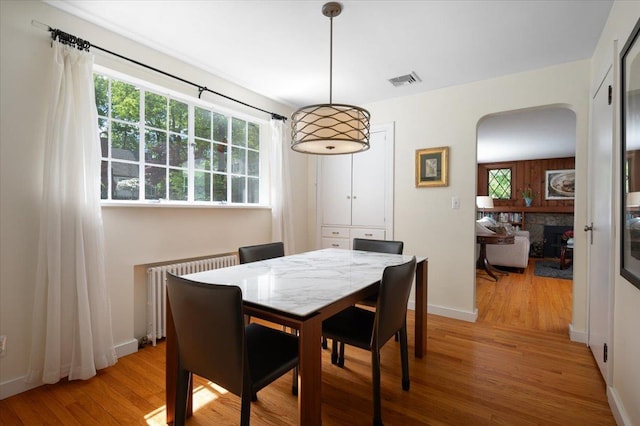 3 Reigate Pl, Suffern, NY 10901 - dining room with radiator heating unit, light wood-style floors, plenty of natural light, and arched walkways