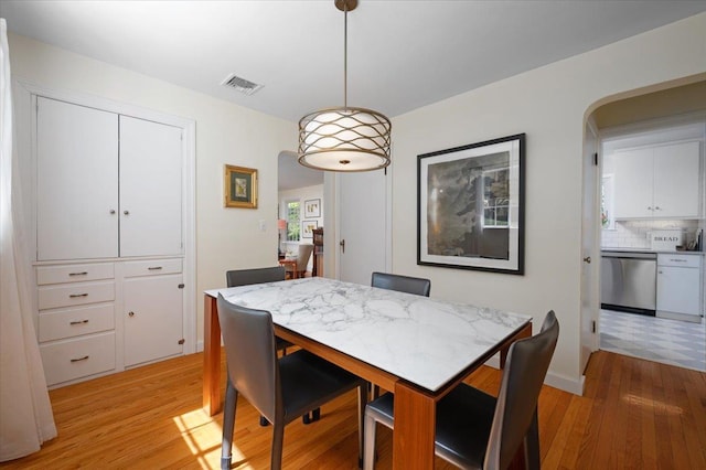 3 Reigate Pl, Suffern, NY 10901 - dining room with arched walkways and light wood-style flooring